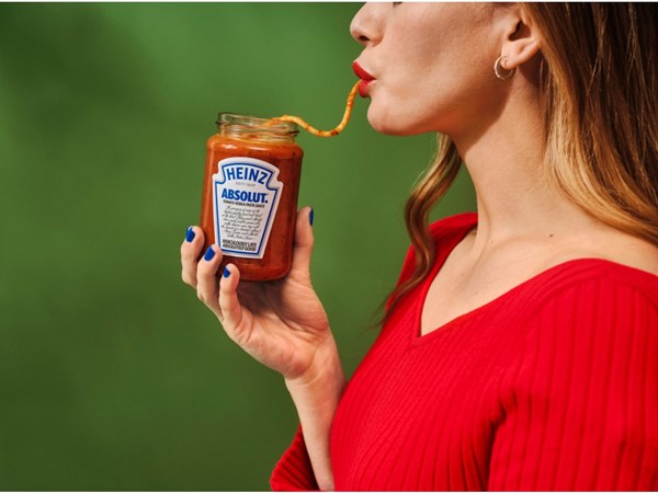 A woman eating spaghetti out of a jar